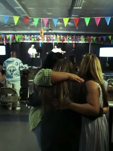 Friends embracing during a gathering at Authentic Community Church